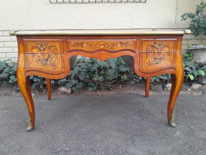 A 20th Century French Style Mahogany And Mahogany Marquetry Inlaid Desk With Brass Caps And Drawers