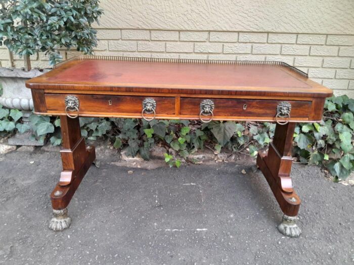 A 19th Century William IV Rosewood Desk with Gilt Tooled Leather and Gilt Metal Gallery Top on Bronze Lion Claw Feet