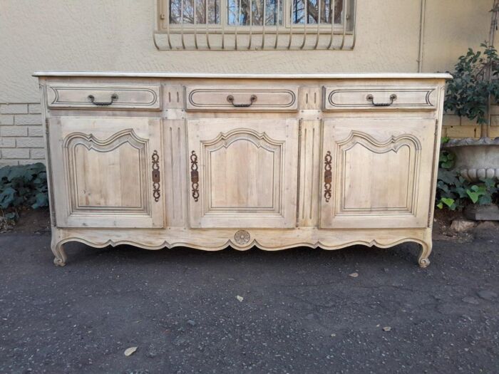 A 20TH Century French Walnut Sideboard with Original Iron hinges in a Contemporary Bleached Finish