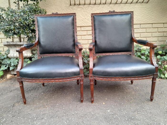 A 19th Century French Pair of Carved Walnut Armchairs Upholstered in  Leather