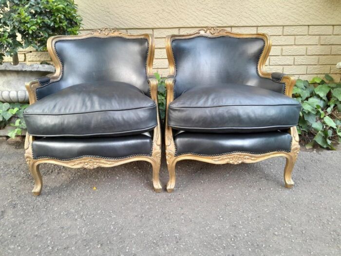 A 20th Century Pair of French Style Carved Giltwood Armchairs Upholstered in Leather