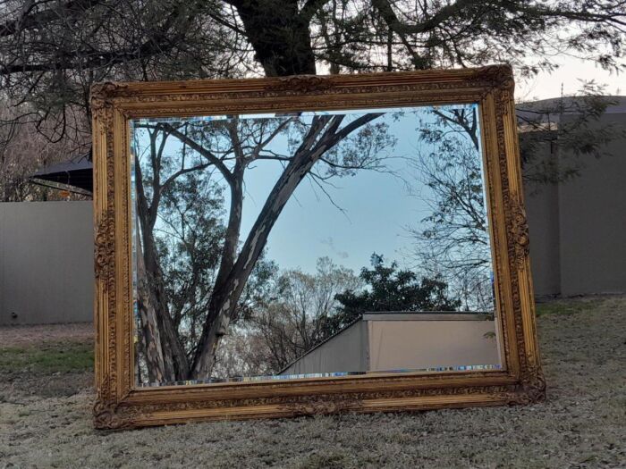 A Massive 20TH Century French Style Ornately Carved And Gilded Bevelled Mirror Of Large Proportions