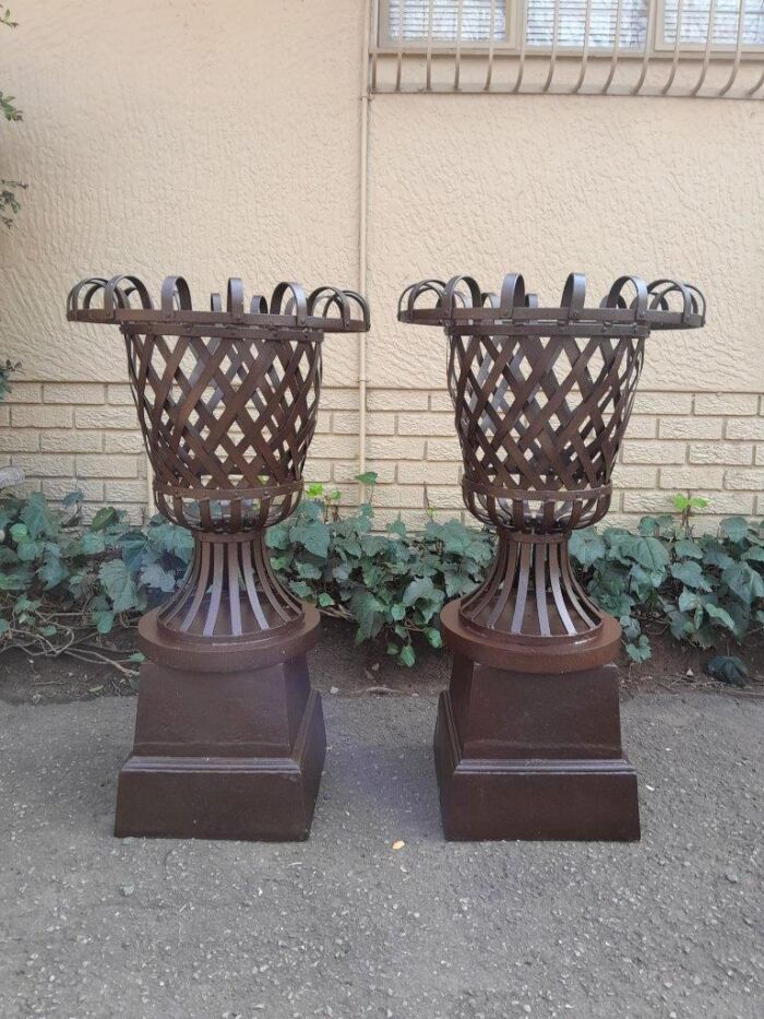 A 20th Century Pair of Decorative Wrought Iron Urns on Plinths