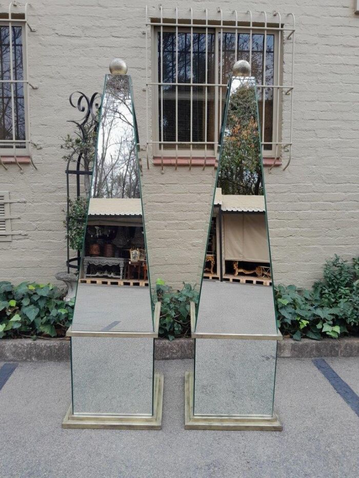 A Pair of Designer Mirror and Antique Gold Coloured Iron Ball and Detail Obelisks