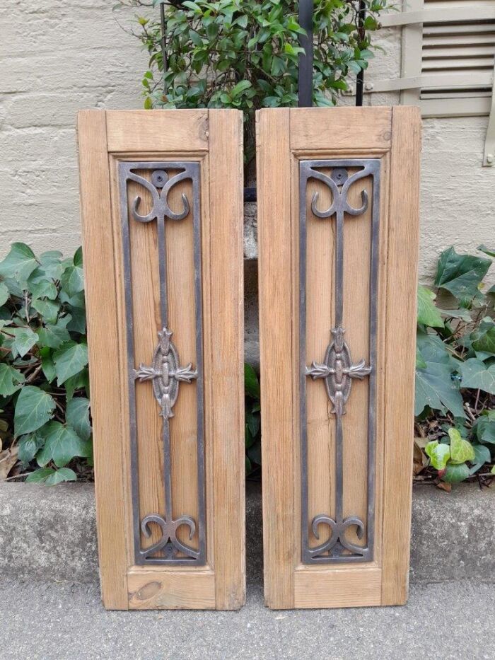 A 20th Century Pair of French Decorative Bevelled Wooden Wall Panels with Wrought Iron Design Elements In a Contemporary Bleached Finish (For Either Side of a Mirror)