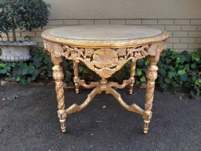 A French Style Ornately Carved and Gilded Wooden Table with Marble Top