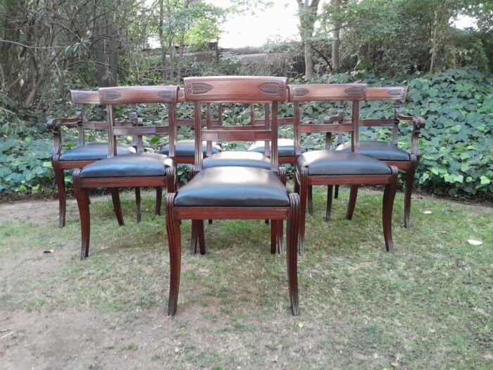 An Antique Late 18th / Early 19th Regency Set of Eight  Mahogany Dining Chairs Upholstered inleather. Comprising: A pair of Carvers and Six Side Chairs