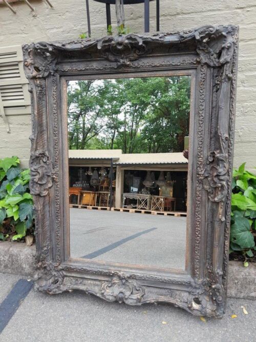 A 20th Century French Style Heavily Carved And Gilded Mirror