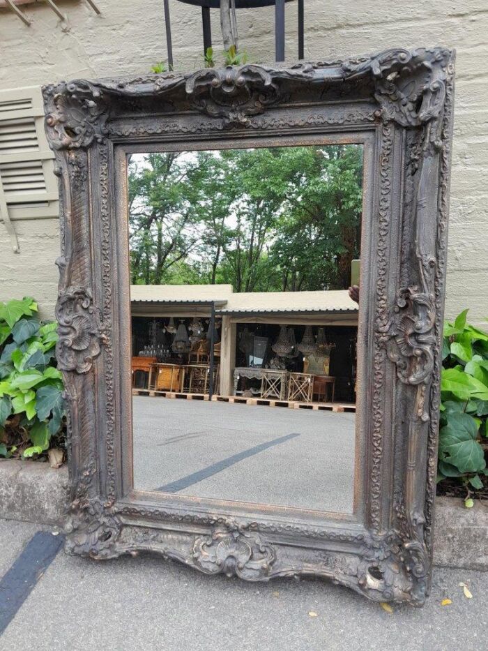 A 20th Century French Style Heavily Carved And Gilded Mirror