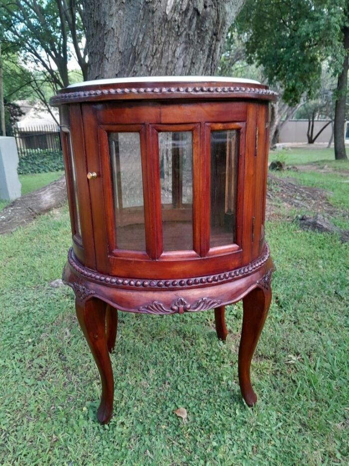 A 20th Century Victorian Ornately Carved Mahogany Drinkscabinet With Cream Marble Top