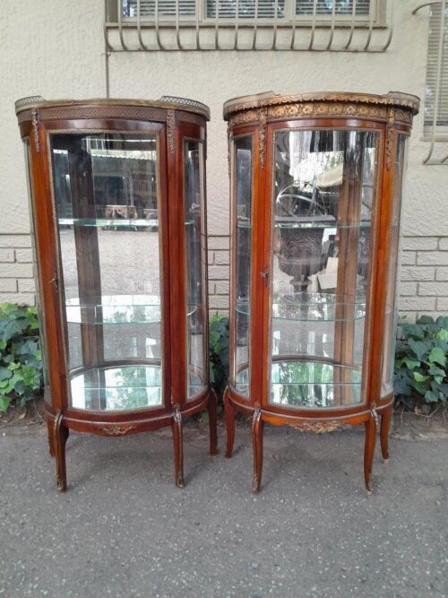 A Rare Near Pair of 20th Century French Style Vitrine / Display Demi Lune Cabinets With Brass Gallery And Fittings and Mirror Interior