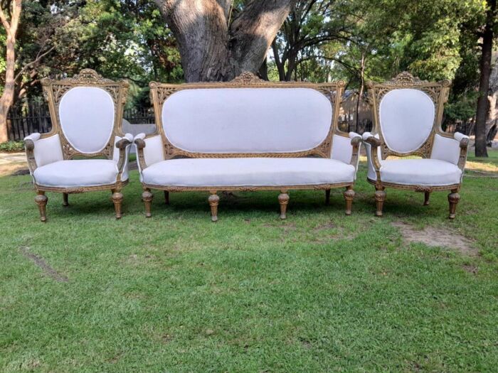 A French Style Giltwood Ornately Carved Settee With A Pair Of Matching Armchairs