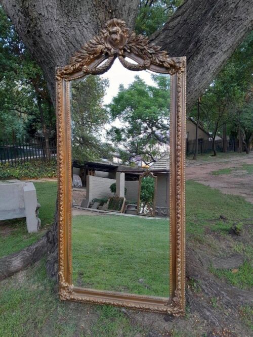 A French Rococo Style Ornately Carved And Gilded Bevelled Mirror