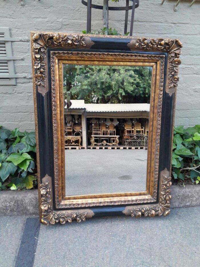 A Bevelled Glass Mirror In An Empire Style Frame