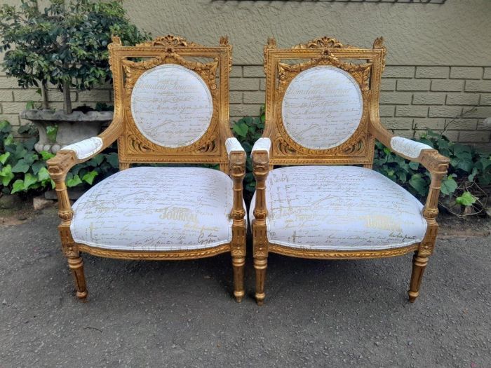 A 20th Century Pair Of French Ornately Carved And Gilded Armchairs - Image 2