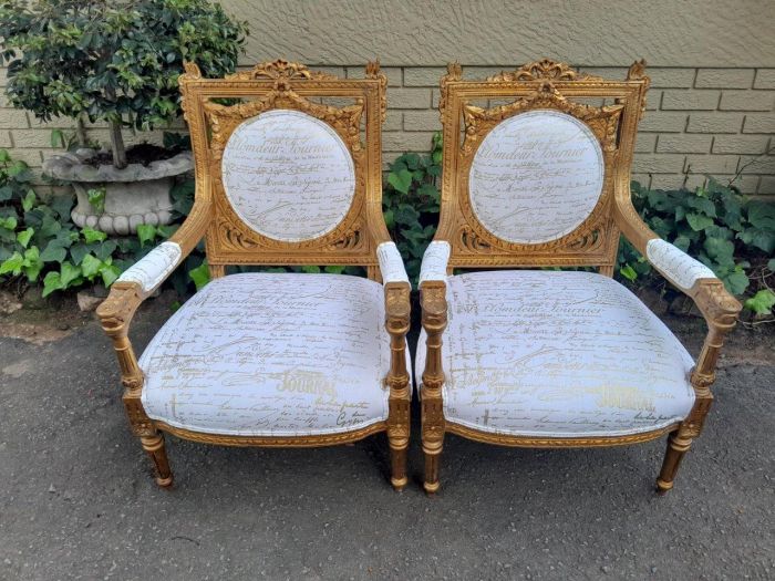 A 20th Century Pair Of French Ornately Carved And Gilded Armchairs - Image 3