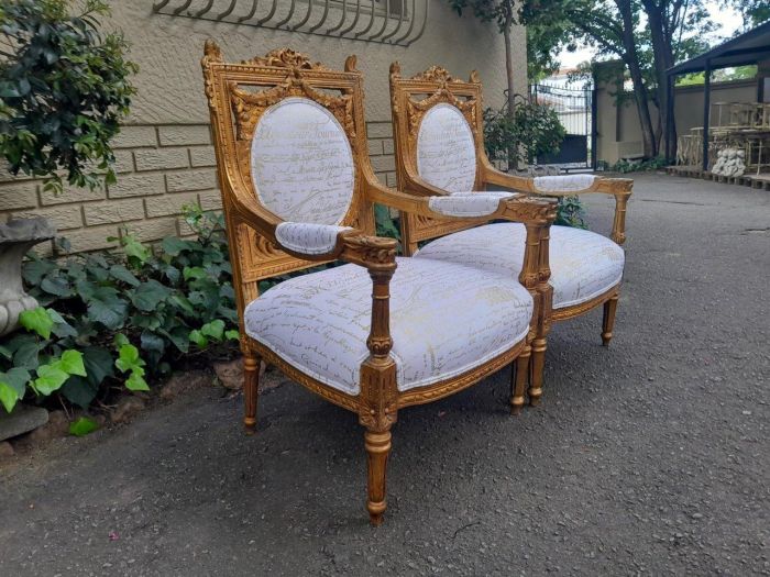 A 20th Century Pair Of French Ornately Carved And Gilded Armchairs - Image 4