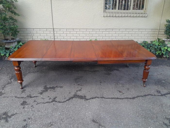 An Antique Edwardian Extending Dining Table with Heavily Carved Legs on Castors and with Crank Handle - Image 2