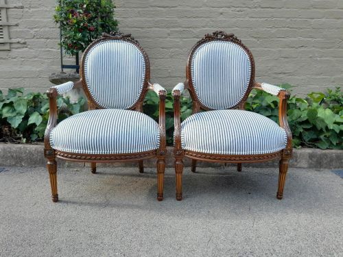 A 20th Century French Pair Of Gilded Mahogany Arm Chairs Upholstered In A Ticking Fabric 