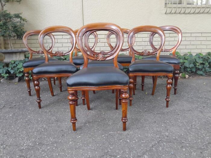 A 20th Century Set of Eight Victorian Style Mahogany Dining Chairs Upholstered in Leather