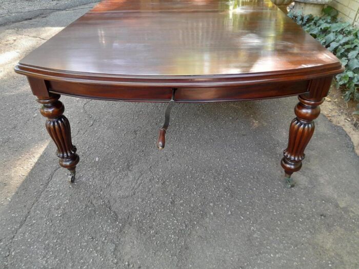 An Antique and Massive Victorian Mahogany Extending Table with Two Extensions and Original Castors and Crank Handle - Image 4