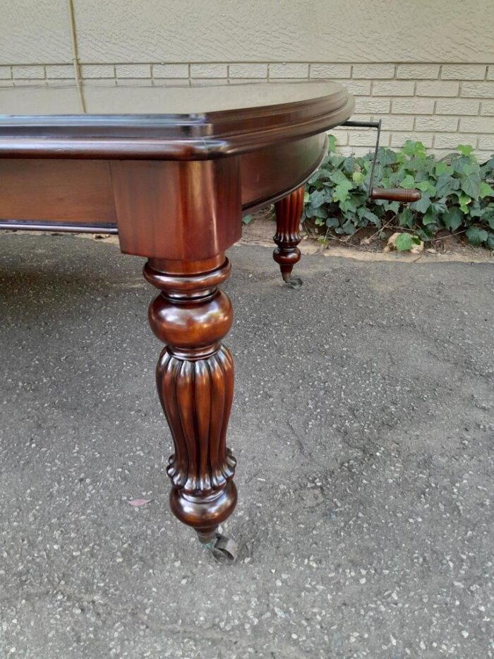 An Antique and Massive Victorian Mahogany Extending Table with Two Extensions and Original Castors and Crank Handle - Image 6