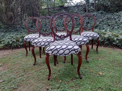 An Antique Victorian Walnut Set of Six Ornately Carved Chairs