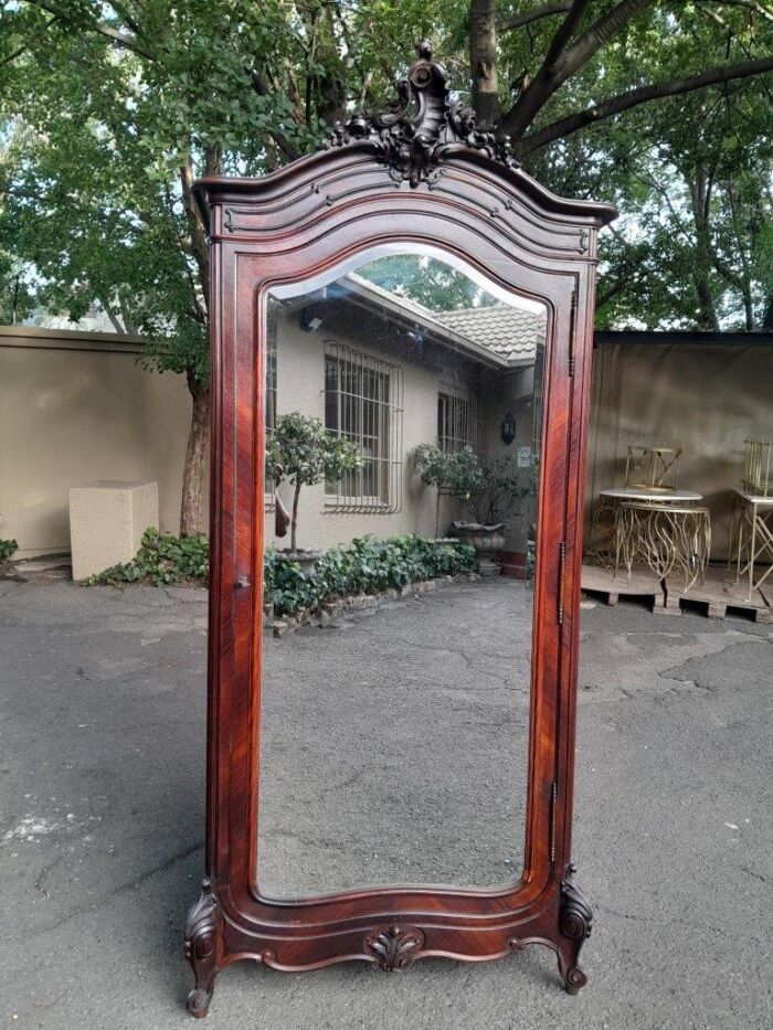 An Early 20th Century French Carved Rosewood Armoire with Bevelled Mirror and Lock and Key