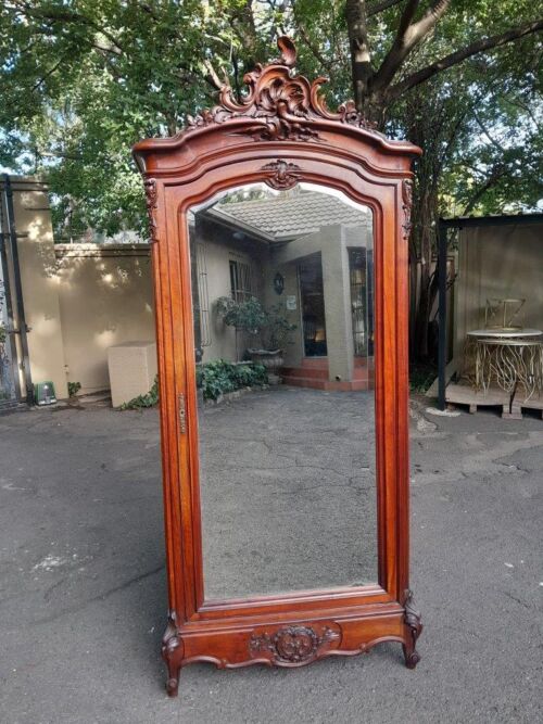 A 20TH Century Circa 1900s French Carved Mahogany Armoire with Bevelled Mirror and Five Shelves