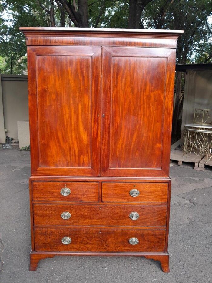 An Antique Circa Victorian Circa 1890s Mahogany Linen Press with Brass Handles  Five Shelves and  Ebony and Walnut Banding with Lock and Key