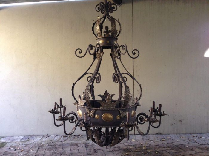 A Large Wrought Iron and Hand-Painted Imported Chandelier with Crown Detail - Image 2