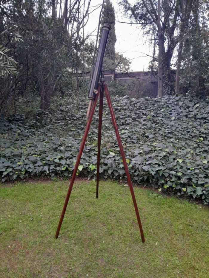 An Antique Early 20th Circa 1920 Century British T. Cooke And Sons Ltd. Brass And Black Painted Telescope With Makers Name (Company Originally Founded By Thomas Cooke In 1837) With Lens Cap On Oak Folding Tripod