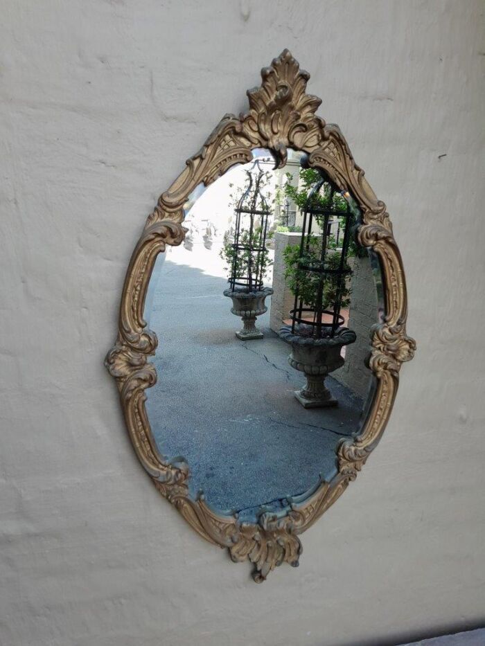 A French Style Ornately Carved Gilt Wood Bevelled Mirror