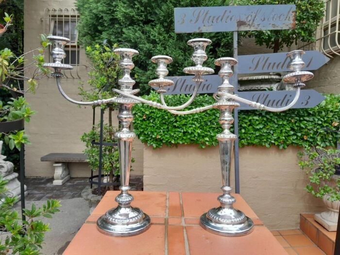 A 20TH Century Pair of Silver Plated Embossed Candelabra