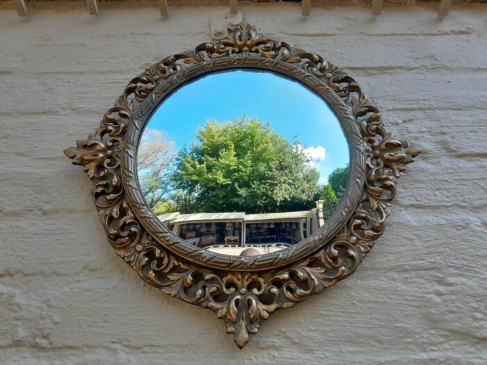 An Early 20th Century Circa 1920 Ornately Carved Giltwood Convex Mirror