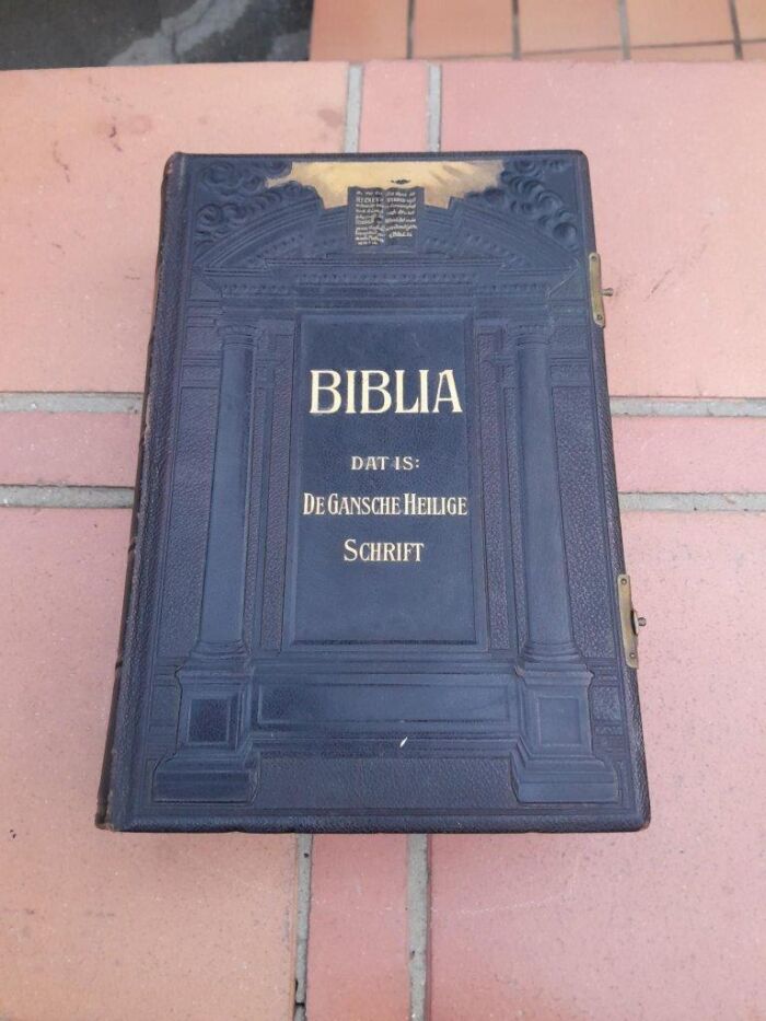 A Leather Bound Bible With Brass Clasps And Mounts