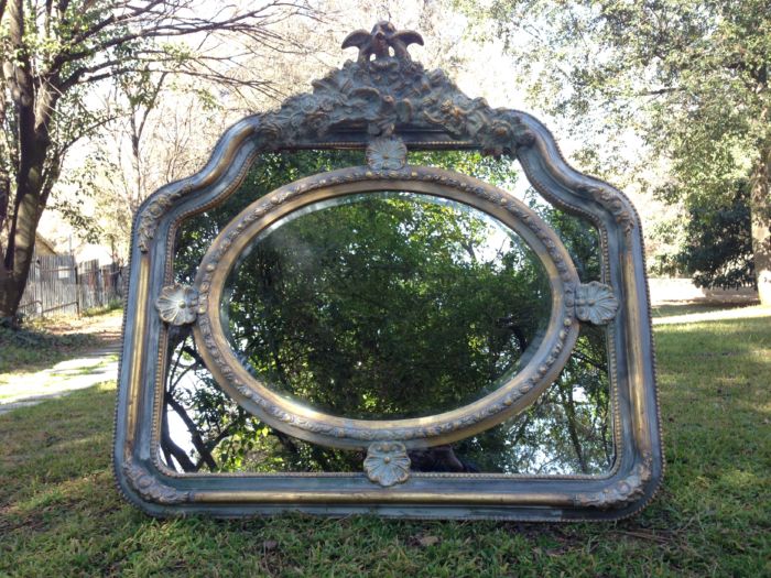 A French Ornate carved painted mirror with a bevelled centre section